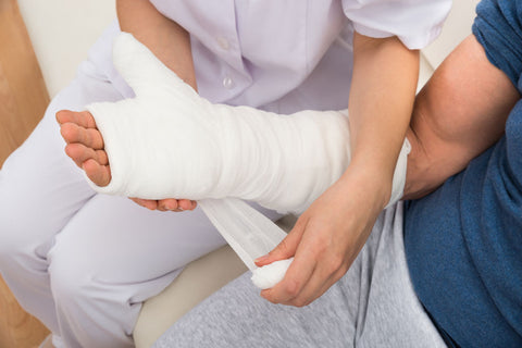 Nurse applying a cast to a broken arm