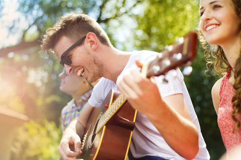 happy friends playing guitar