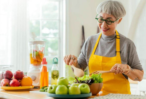 elder woman preparing a healthy meal