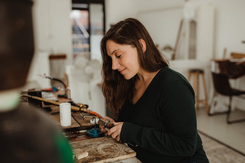 Claire hand crafting jewellery at a local studio
