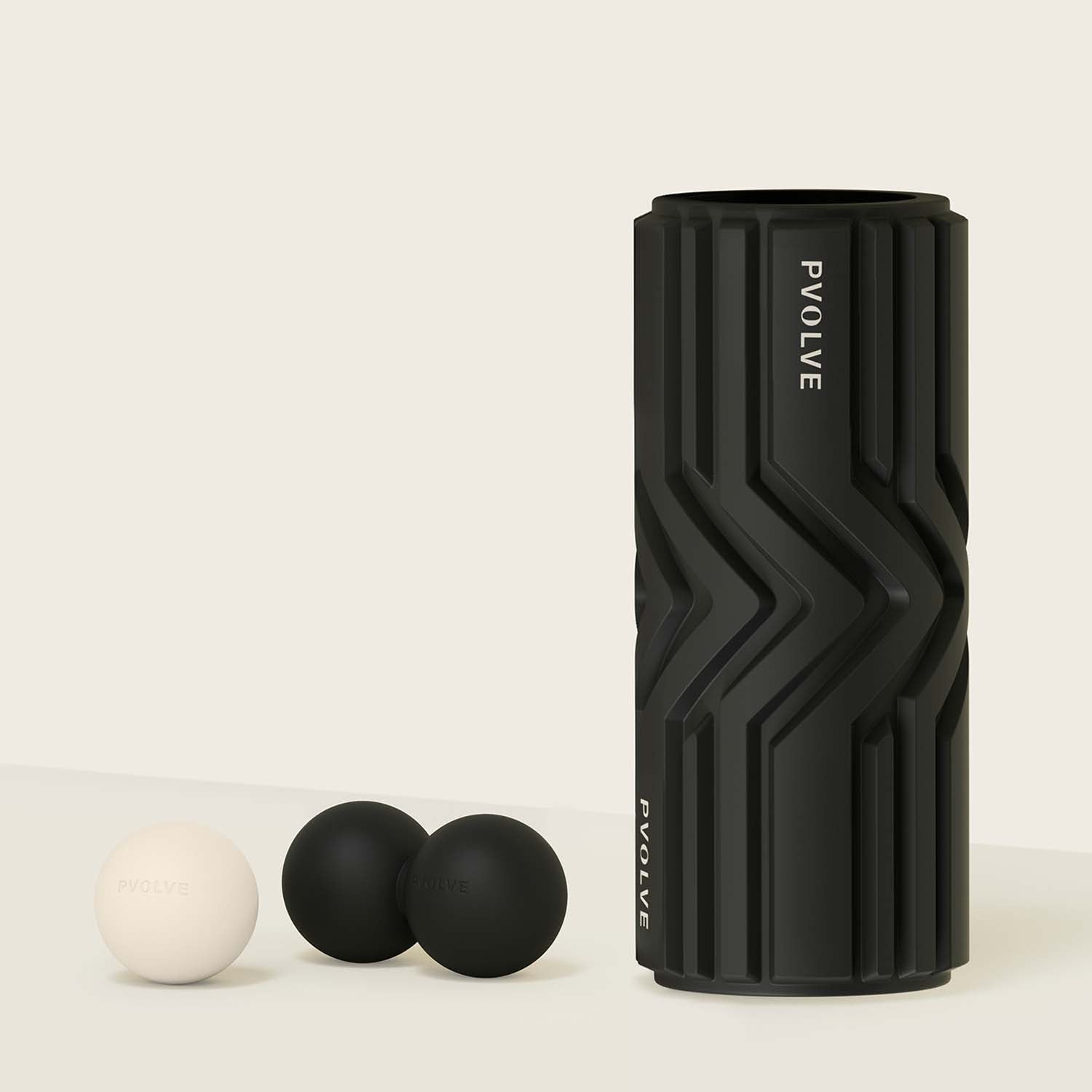 P.volve foam roller with two black balls and one white ball.