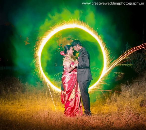 Image of Beautiful Indian Gujarati couple in Indian traditional dress  lightening Diwali diya/lamps sitting on the floor in darkness on Diwali  evening. Indian lifestyle and Diwali celebration-LJ148195-Picxy