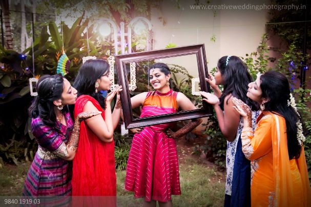 Photo of Bride posing with bridesmaids.