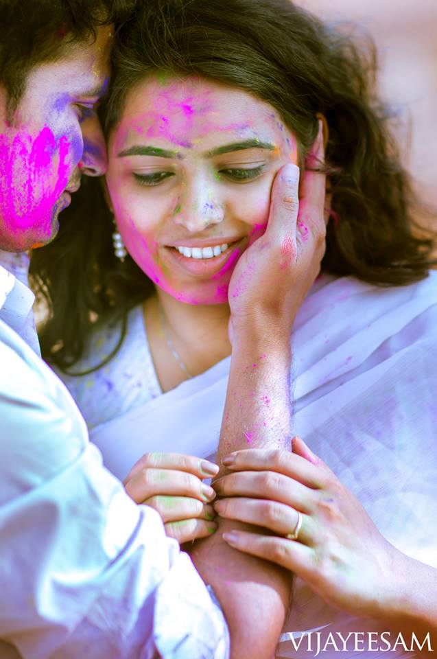 Beautiful Indian young woman with face paint during the Holi India Kerala  Festival Stock Photo by wirestock