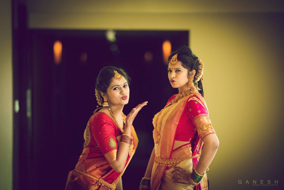 Just fooling around. Two sisters twins standing and posing in the studio  with white background Stock Photo - Alamy