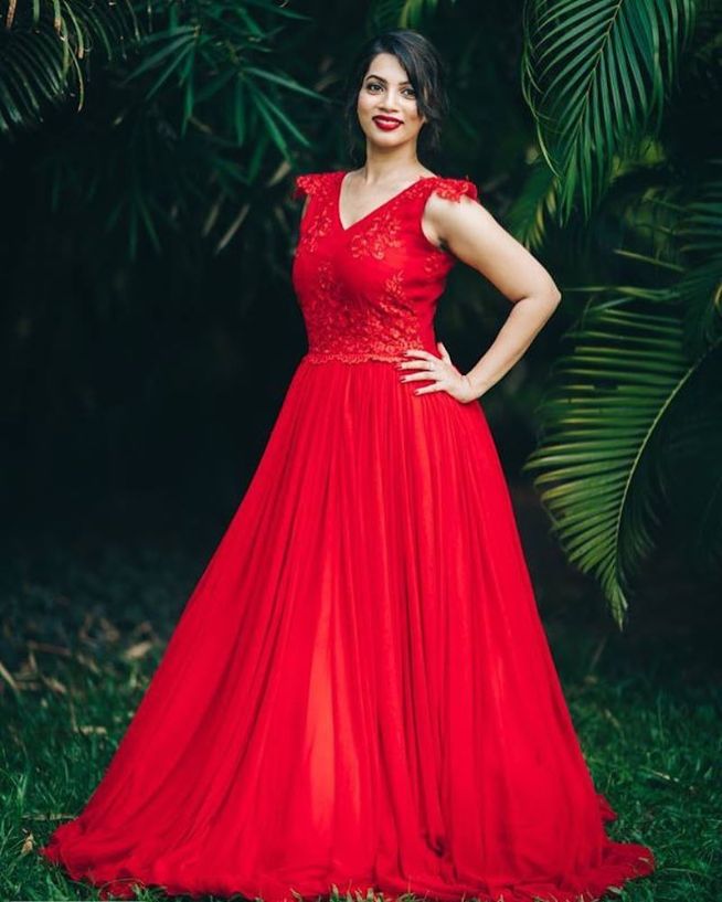 A Beautiful Girl In A Long Red Ball Gown Standing On The Balcony Against  The Background Of An Autumn Park In The Twilight Light. Stock Photo,  Picture and Royalty Free Image. Image