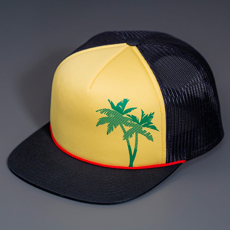 A Rasta Palm Tree Printed Foam Front, Black Mesh Backed, Blank Trucker Hats with a Flat Bill, & Classic Snapback.  Designed By Blvnk Headwear.