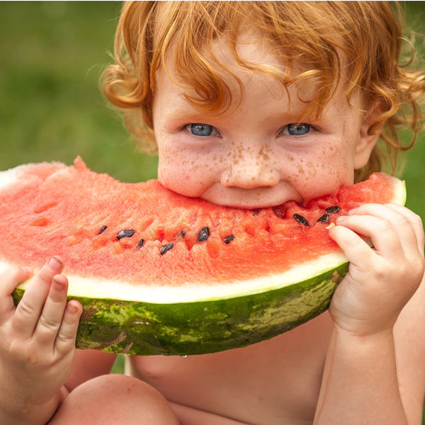 child eating fresh watermelon