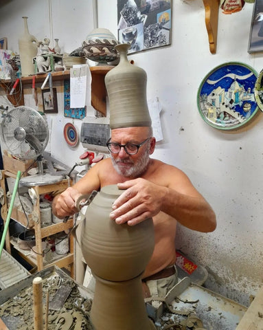 Photo of Liguori working on pottery