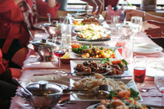 Close up of dinner table with shared dishes in the middle