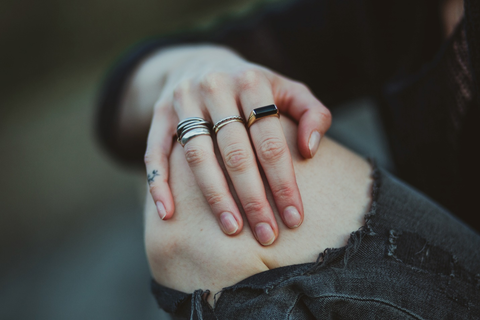 Person putting a hand on their exposed knee.