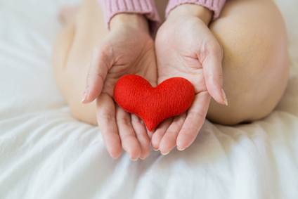 A person holding a heart-shaped object