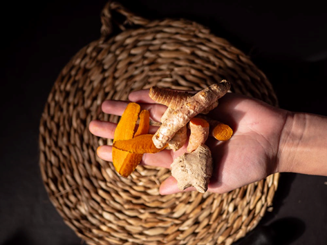 a person holding turmeric 