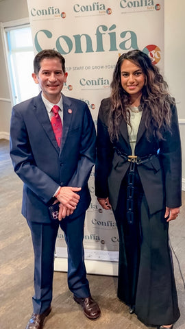 Melissa Desk to Dusk owner with Fresno State University President, Dr. Saul Jimenez-Sandoval. Melissa is wearing a Desk to Dusk Mona Pant Suit in Black with a statement belt, depicting what women's Business-Formal attire looks like for professional events