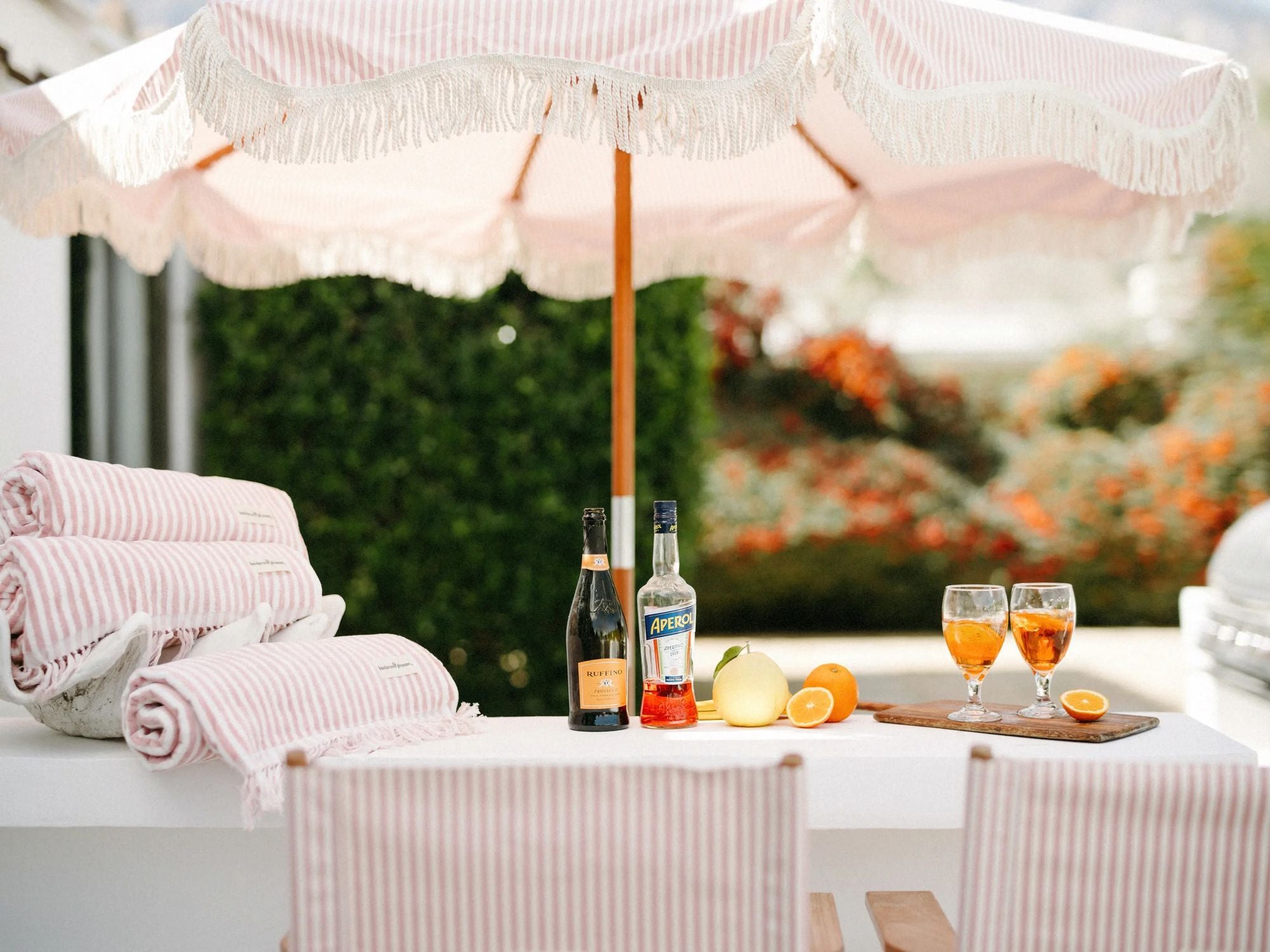 Pin Striped umbrella and tables with a spritz drink