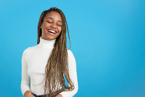 smiling african american woman with braids hairstyle