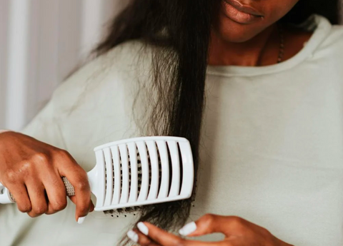 African American Woman Brushing Her Textured Hair