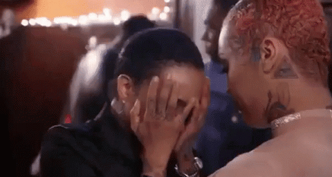 african american woman with short natural hair crying and her friend comforting her