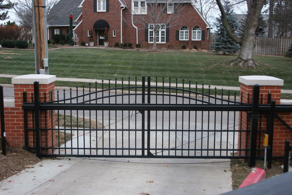 Ornamental sliding cantilever gate in front of a driveway