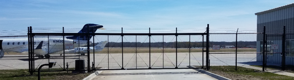 Airport runway secured by a cantilever slide gate with gate automation