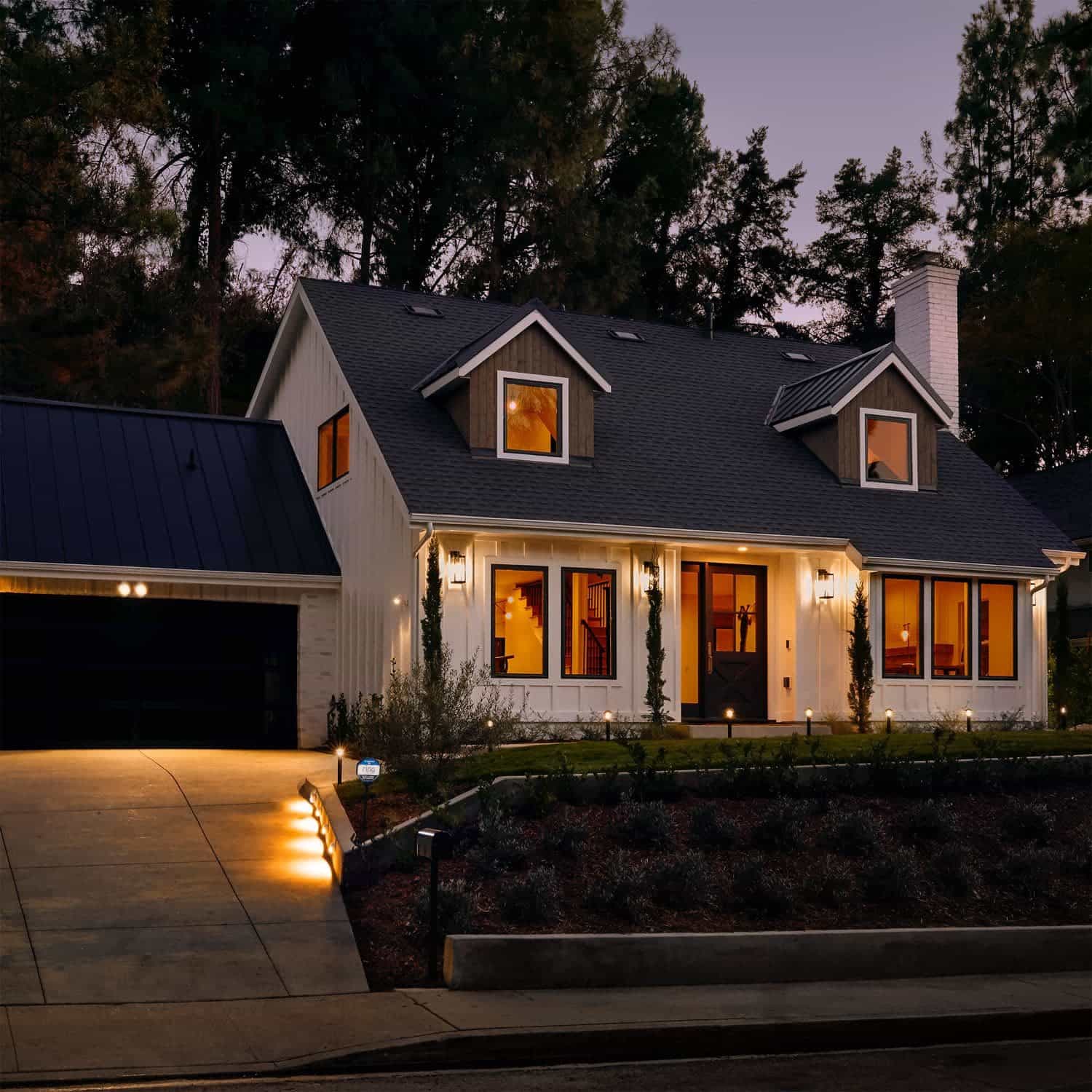 Smart Lighting Spotlight Battery - Outside at dusk, a home is lit up with an array of Ring Smart Lighting products, including the Spotlight Battery.