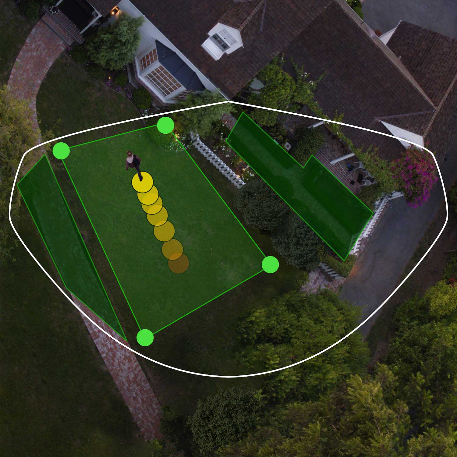 Floodlight Cam Wired Pro - Aerial view of front of house showing bird's eye view zones in green. Person walks toward front door, their path indicated by yellow dots.