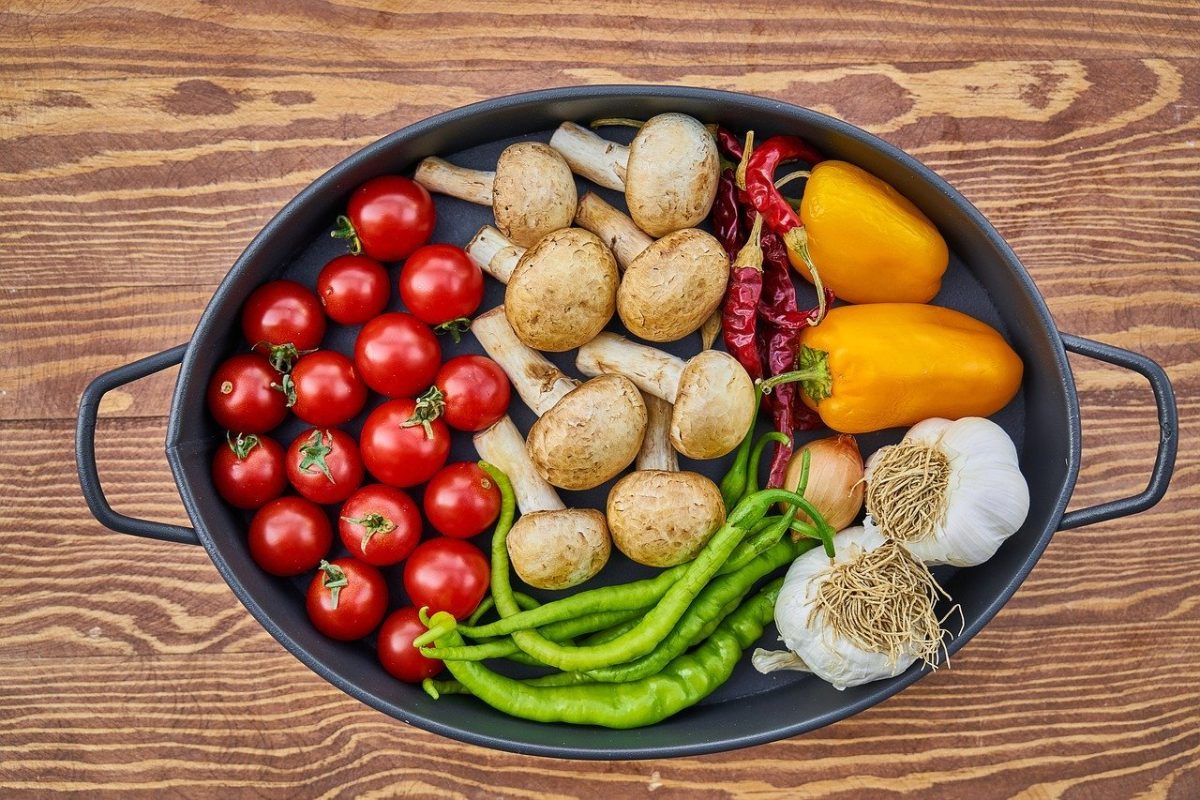 A skillet with healthy fruits and vegetables to help joint health.