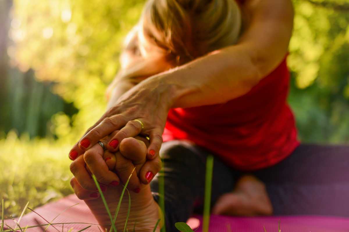 A person stretching while practicing yoga.