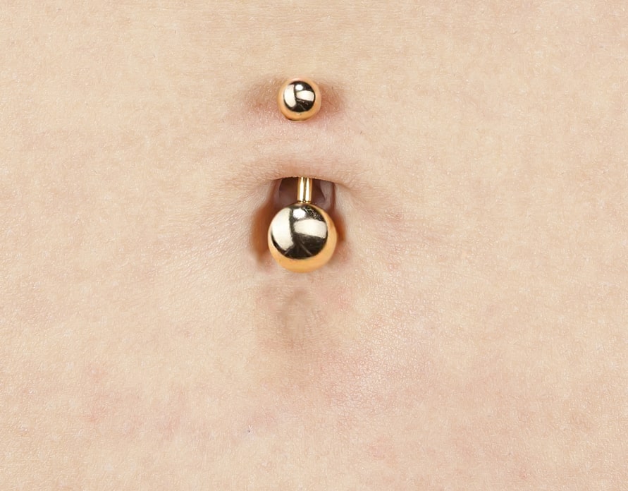 What to Know About “Floating Belly Button Piercings