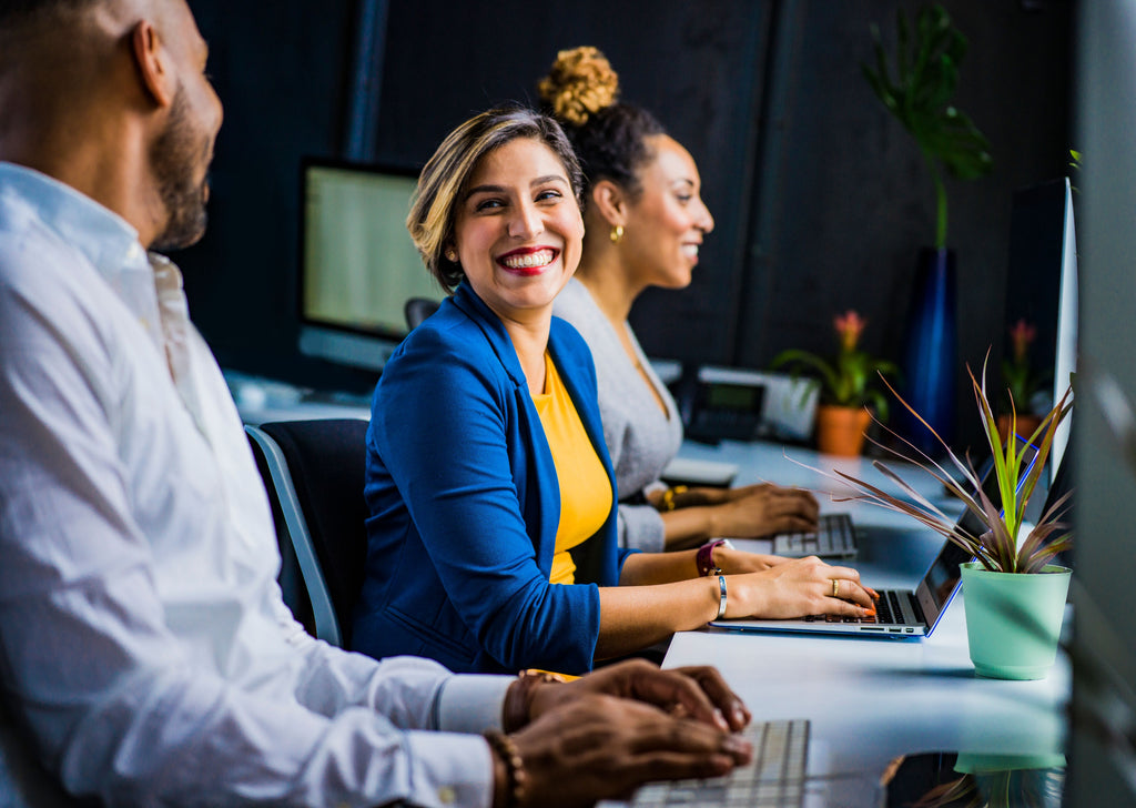 three persons working at the office