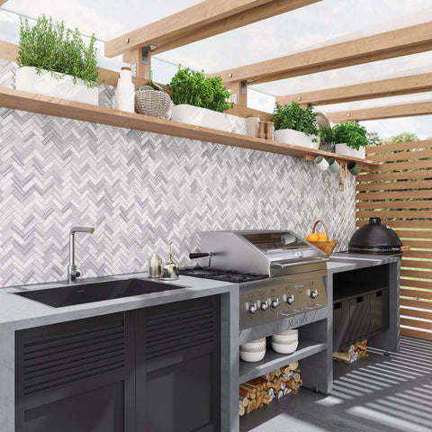 Outdoor kitchen and grill area with Equator Herringbone Polished Mosaic Tile backsplash