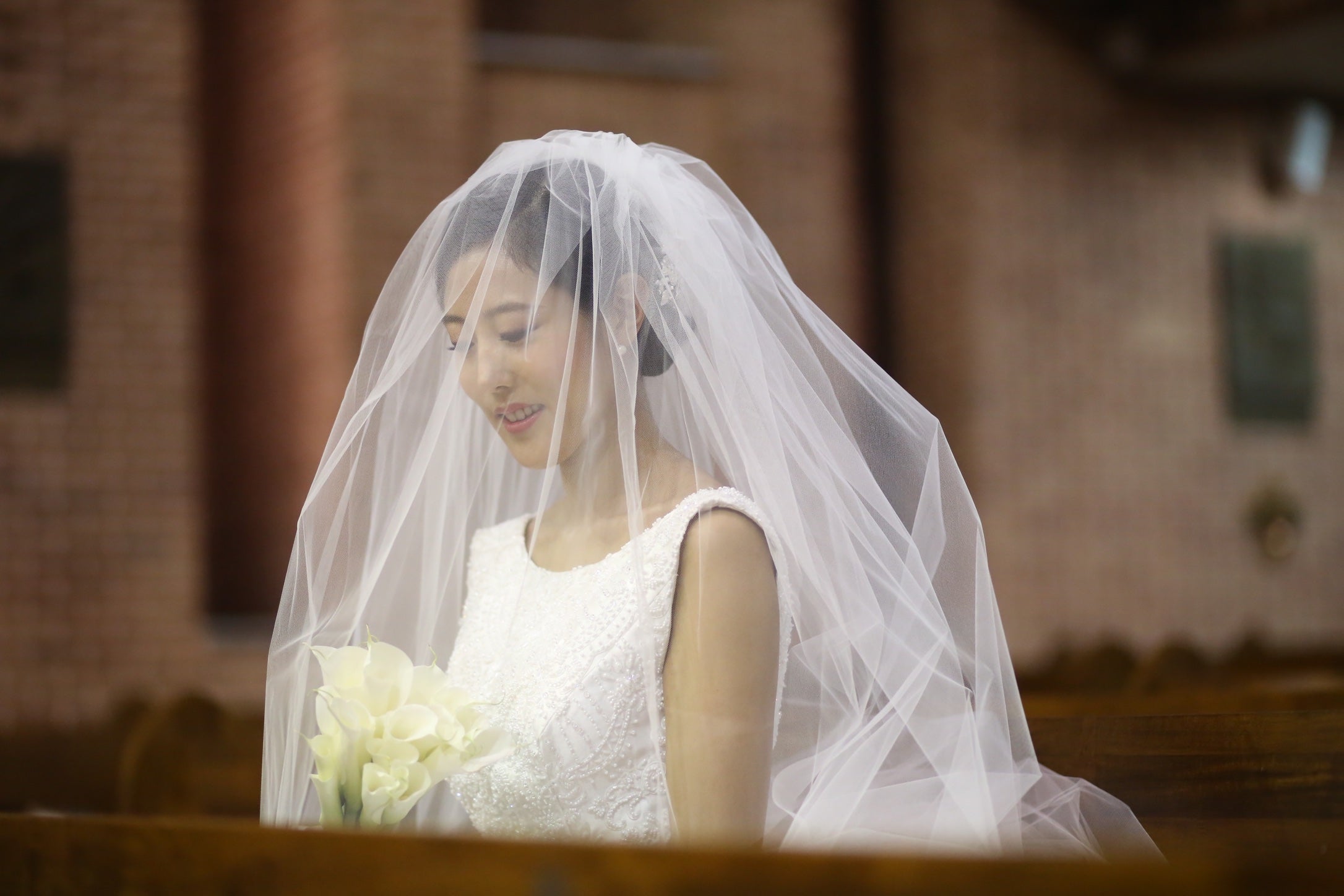 woman smiling in white wedding dress