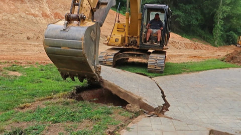 Excavator Bucket Lifting Concrete Slabs