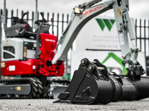 Willowbrook Takeuchi digger and multiple black rhinox buckets