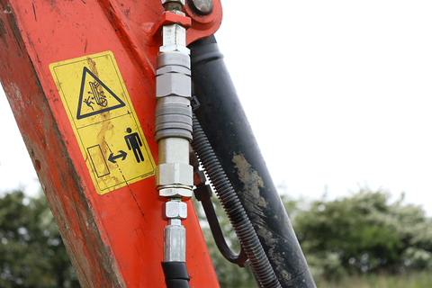 Auxiliary ports on a kubota digger with hydraulic hoses plugged in