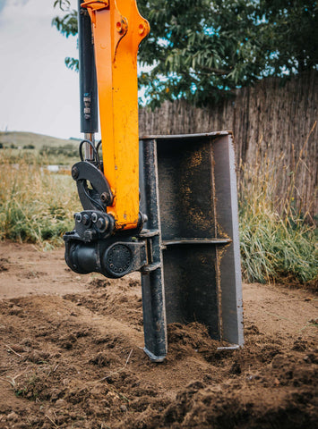 Digger fitted with a Miller Tilting hitch. Showing a grading bucket tilted to 90 degrees