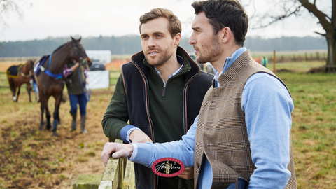 2 men watching the horse racing