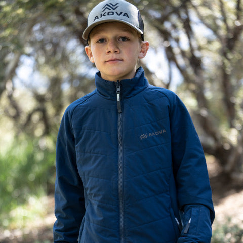 Boy wearing navy blue Akova puffy