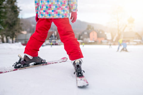 Girl preparing to ski downhill