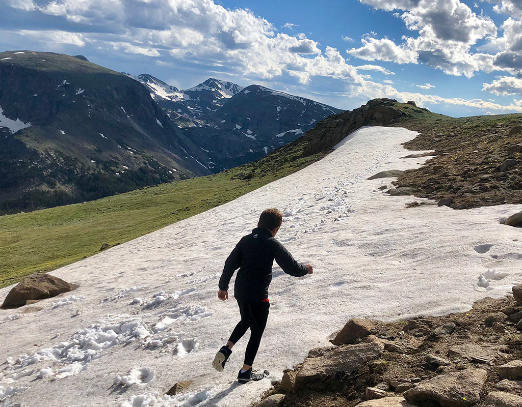 Kid exploring playing in snow while hiking