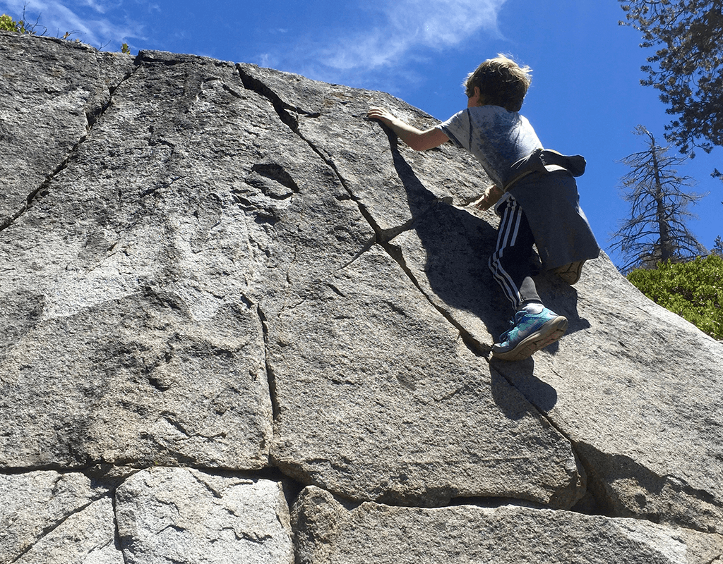 kid scrambling on rocks