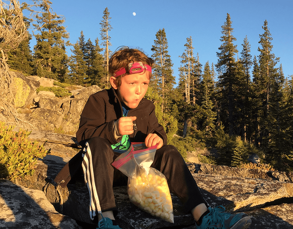 kid taking a break after hiking