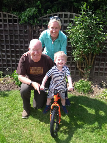 Child on bike with grandparents