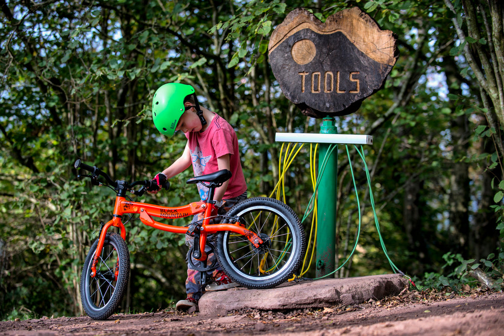 Boy standing with SKOG bike