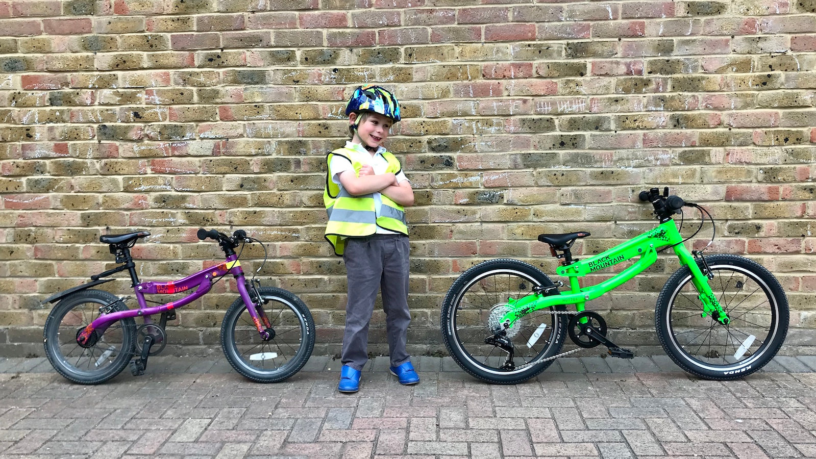 Child in reflective vest with old and new bike