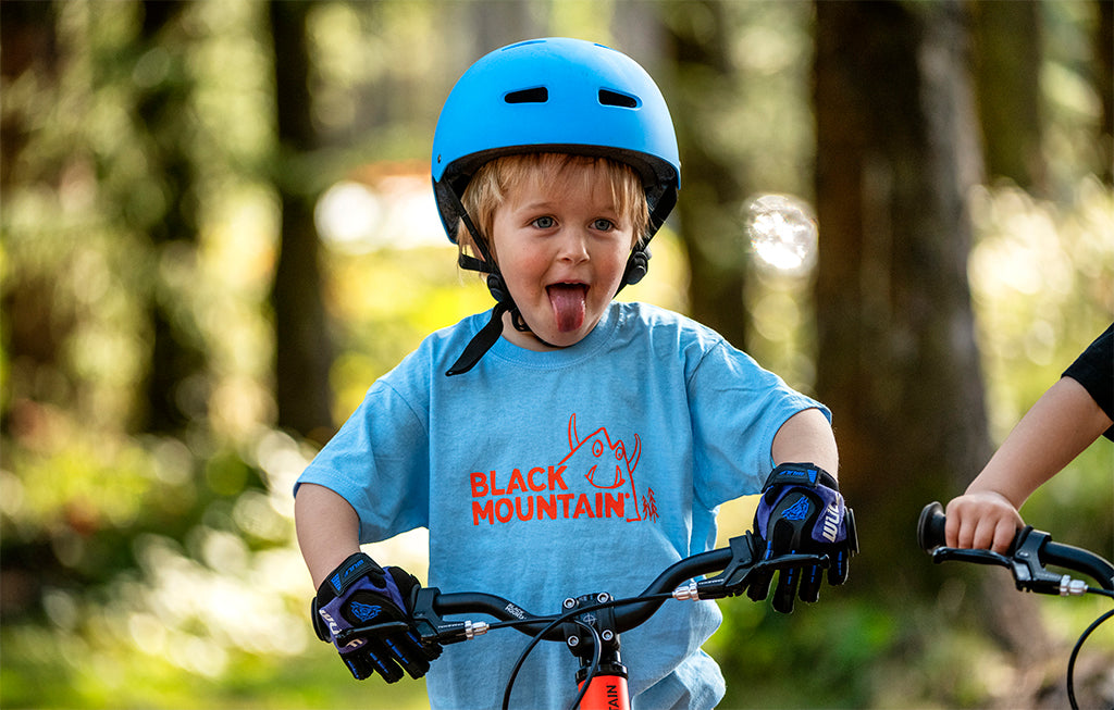 Boy on kids bike in blue t shirt