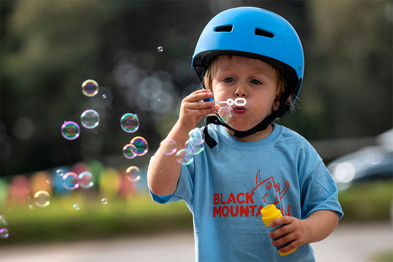 Young cyclist blowing bubbles