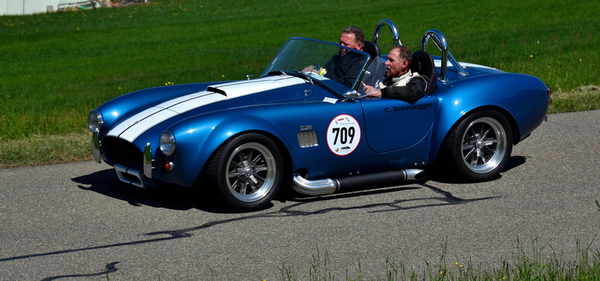 Shelby Cobra racing on a racetrack