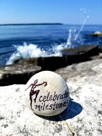 Celebrate milestones painted rock by Bethany Kirwen USA