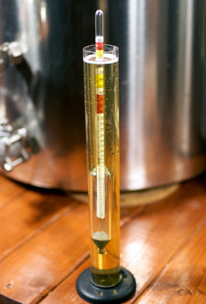 Measuring specific gravity with a hydrometer in a test jar